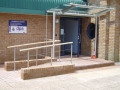 Stainless and glass entrance canopy and timber railed balustrade...