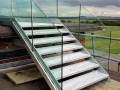 Galvanized escape stair with frameless glass balustrade at Boscombe Down Air Control Tower.