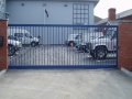 Blue (with silver wave highlight) sliding gate at Weymouth Sea Cadet Centre