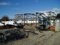 Fixing purlins to previously erected structural frame